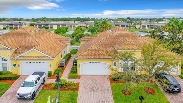 4737 Casswell Dr, New Port Richey, FL 34652 - view of front of property with a tile roof, decorative driveway, stucco siding, and a garage