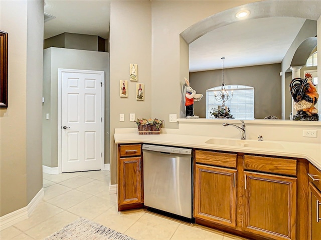 4737 Casswell Dr, New Port Richey, FL 34652 - kitchen featuring stainless steel dishwasher, a sink, arched walkways, brown cabinets, and light tile patterned flooring