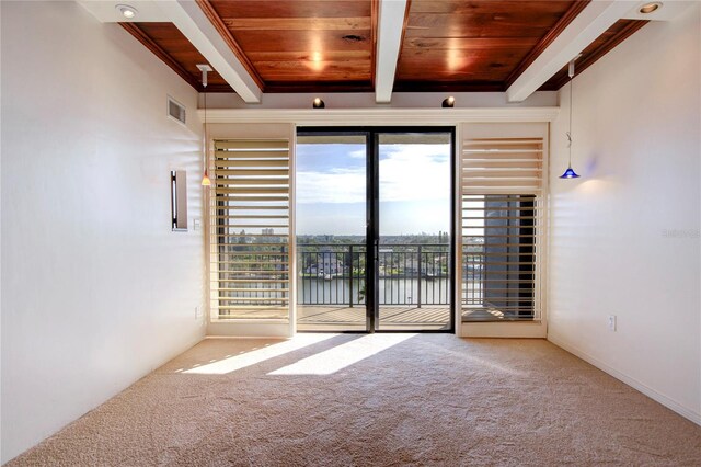 spare room featuring carpet, wood ceiling, a water view, and beamed ceiling