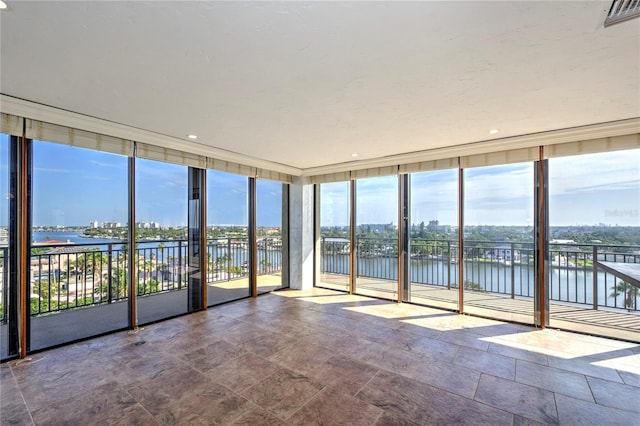 unfurnished sunroom featuring a water view and visible vents