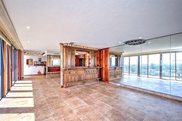 interior space with a textured ceiling, floor to ceiling windows, and recessed lighting