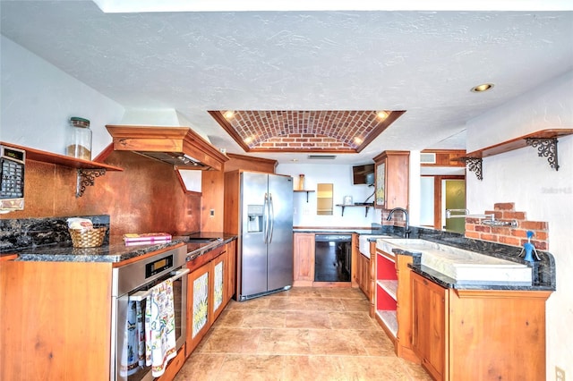 kitchen featuring appliances with stainless steel finishes, a peninsula, a textured ceiling, open shelves, and a sink