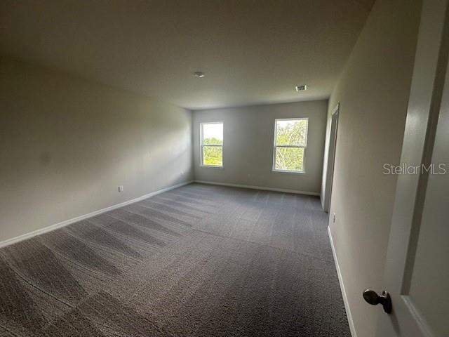 708 160th Ln E, Bradenton, FL 34212 - carpeted spare room featuring baseboards