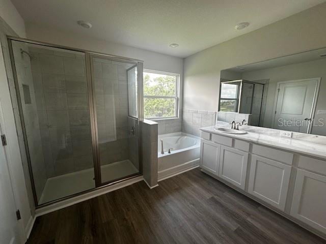 708 160th Ln E, Bradenton, FL 34212 - full bath with a garden tub, wood finished floors, vanity, and a stall shower