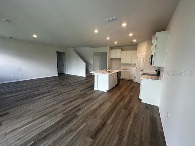708 160th Ln E, Bradenton, FL 34212 - kitchen featuring open floor plan, dark wood finished floors, recessed lighting, white cabinetry, and a sink