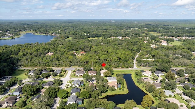 aerial view featuring a forest view, a water view, and a residential view