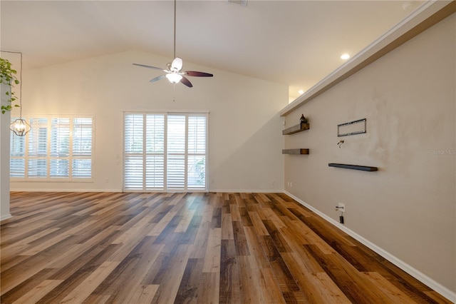 unfurnished living room featuring baseboards, lofted ceiling, wood finished floors, and a ceiling fan