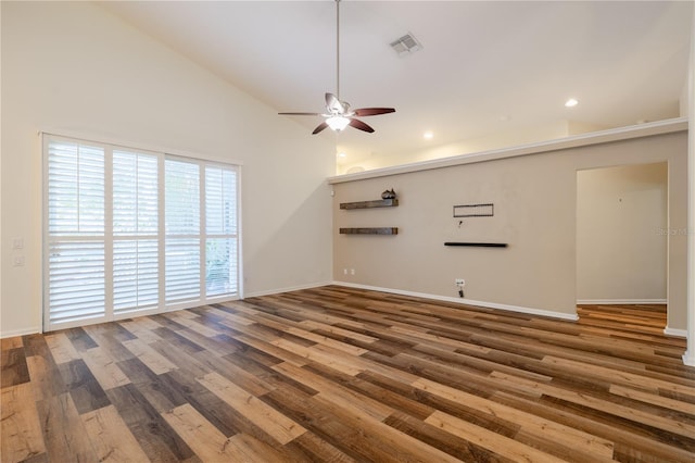 unfurnished living room with visible vents, high vaulted ceiling, wood finished floors, baseboards, and ceiling fan