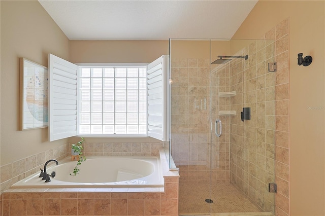 bathroom with a stall shower and a bath