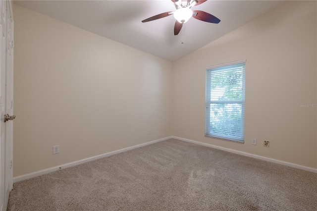 empty room featuring lofted ceiling, baseboards, carpet floors, and ceiling fan