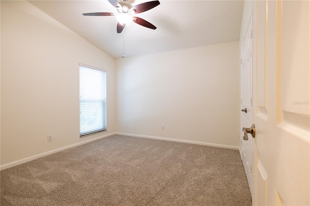 carpeted empty room with baseboards, lofted ceiling, and ceiling fan