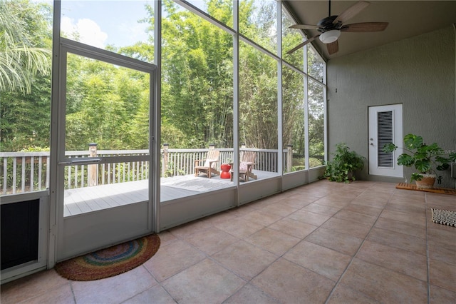 unfurnished sunroom featuring ceiling fan