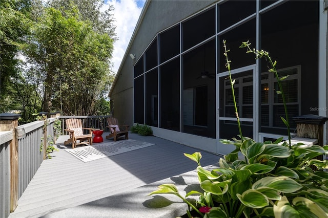 wooden deck with a sunroom