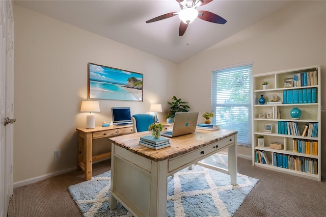 home office featuring lofted ceiling, carpet flooring, baseboards, and ceiling fan