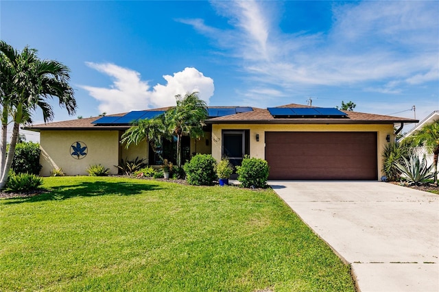 ranch-style house featuring a garage, a front lawn, and solar panels