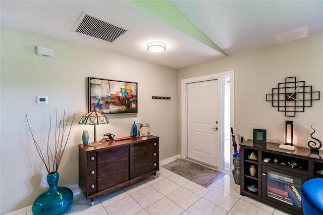 tiled entryway featuring vaulted ceiling