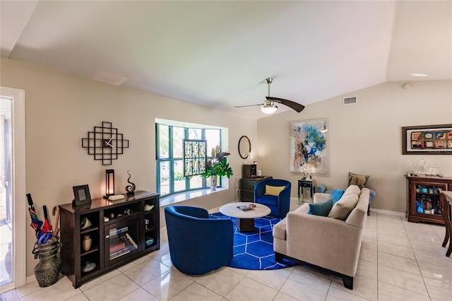 tiled living room with ceiling fan and vaulted ceiling