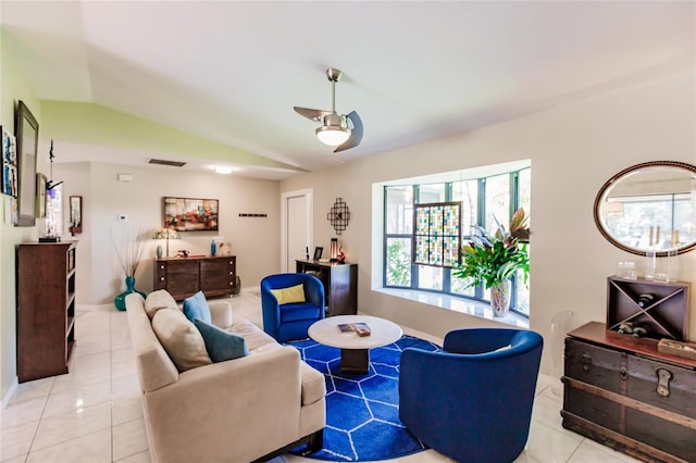 living room featuring lofted ceiling, ceiling fan, and light tile patterned floors