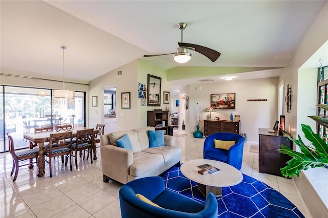 living room featuring ceiling fan, vaulted ceiling, and light tile patterned flooring