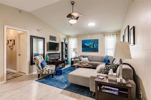 living room featuring light wood-type flooring and vaulted ceiling