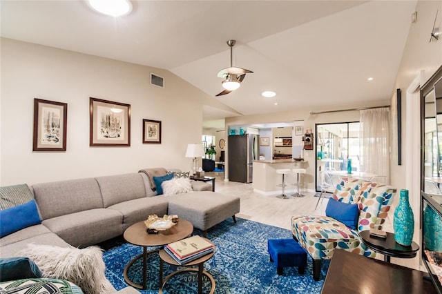 living room with lofted ceiling and light hardwood / wood-style floors