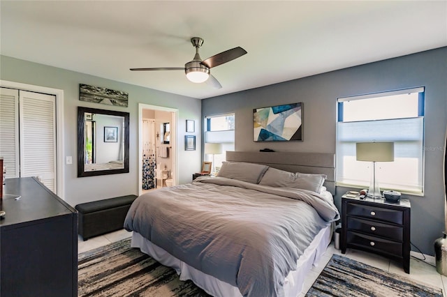 tiled bedroom with a closet and ceiling fan