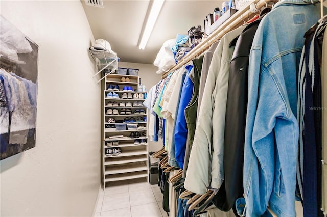 spacious closet with light tile patterned flooring