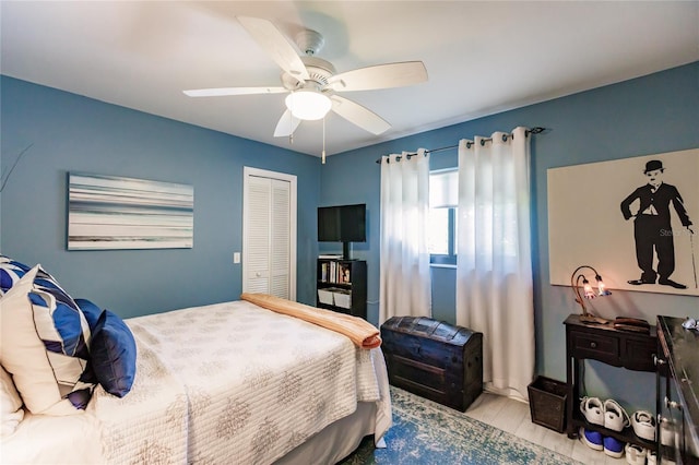 bedroom with ceiling fan, a closet, and light hardwood / wood-style floors