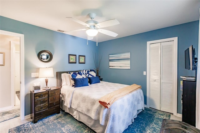 bedroom with ceiling fan, a closet, and wood-type flooring