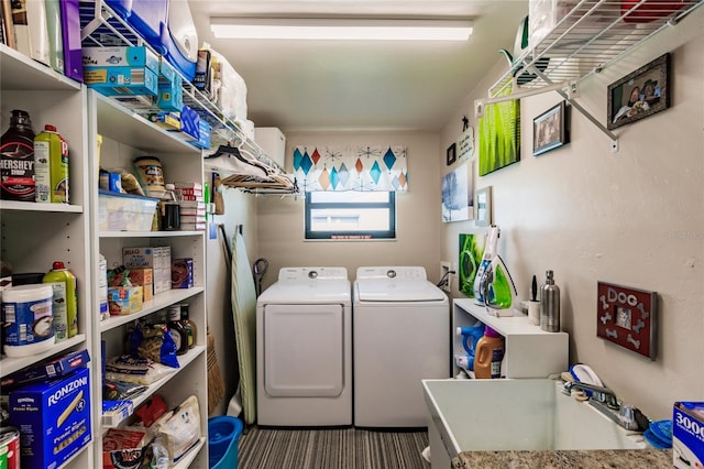 laundry room featuring washing machine and clothes dryer and sink