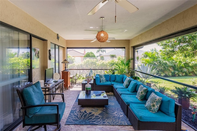 sunroom with ceiling fan