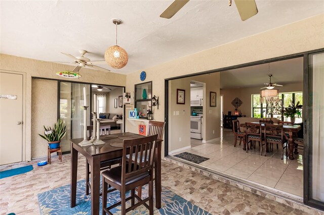 dining room featuring ceiling fan and light tile patterned floors