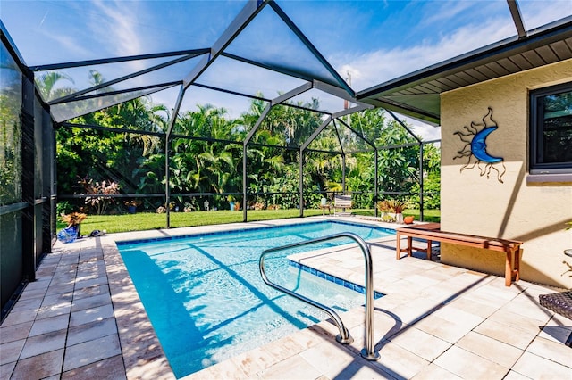 view of pool with a patio area and a lanai