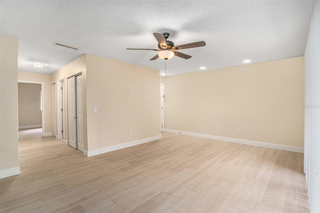 3822 Cortez Dr Unit D, Tampa, FL 33614 - empty room with a ceiling fan, light wood-type flooring, baseboards, recessed lighting, and a textured ceiling