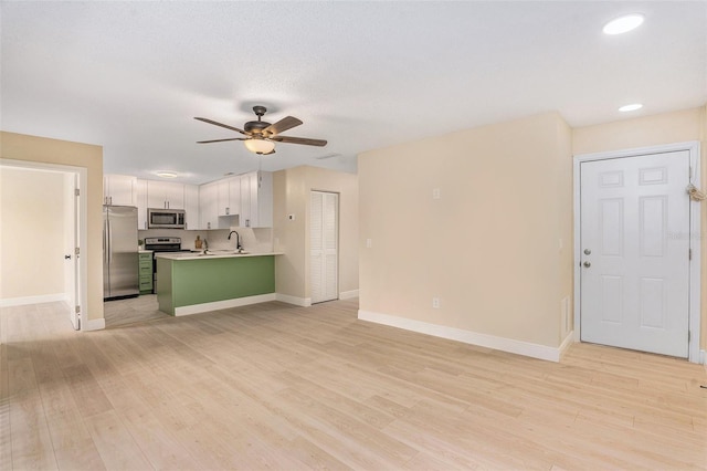 3822 Cortez Dr Unit D, Tampa, FL 33614 - unfurnished living room with a sink, a ceiling fan, light wood-type flooring, and recessed lighting