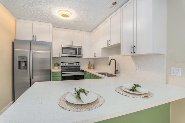 3822 Cortez Dr Unit D, Tampa, FL 33614 - kitchen with appliances with stainless steel finishes, a sink, a textured ceiling, and white cabinetry