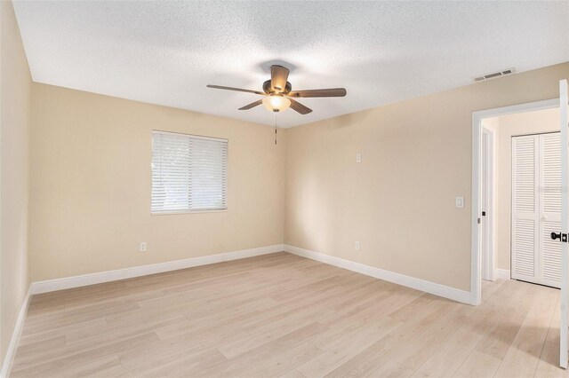 3822 Cortez Dr Unit D, Tampa, FL 33614 - spare room with a ceiling fan, light wood-style flooring, baseboards, and a textured ceiling