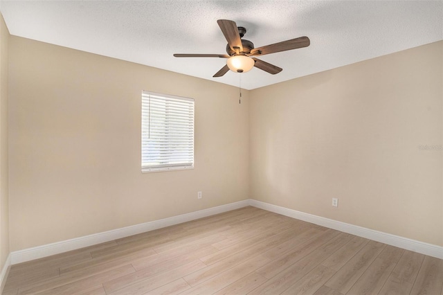 3822 Cortez Dr Unit D, Tampa, FL 33614 - spare room featuring light wood-style floors, ceiling fan, baseboards, and a textured ceiling