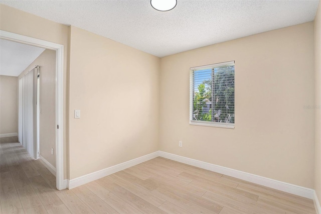 3822 Cortez Dr Unit D, Tampa, FL 33614 - unfurnished room featuring light wood finished floors, baseboards, and a textured ceiling