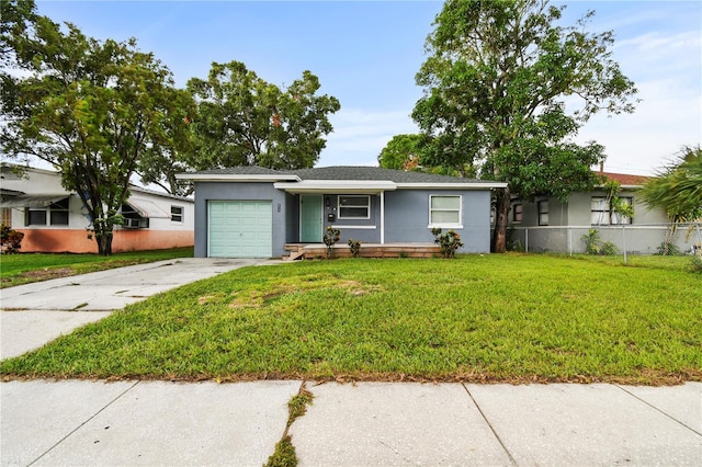 ranch-style home featuring a garage, concrete driveway, fence, a front yard, and stucco siding