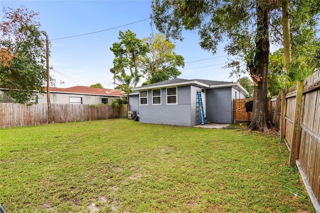 view of yard featuring central AC and a fenced backyard