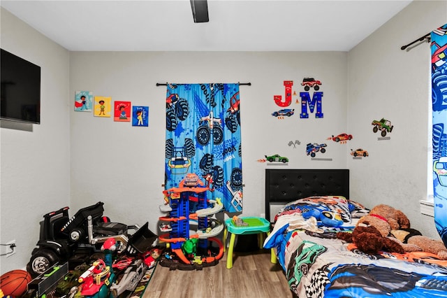 bedroom with ceiling fan and hardwood / wood-style floors