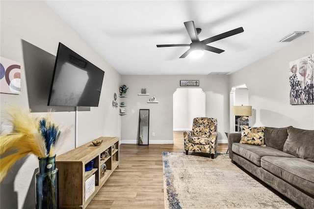 living room with wood-type flooring and ceiling fan