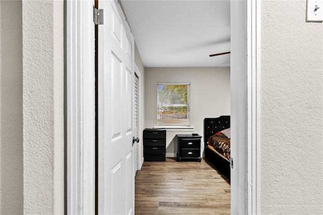 mudroom featuring a textured wall and wood finished floors