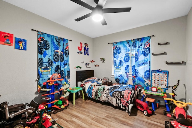 bedroom featuring ceiling fan and light hardwood / wood-style floors