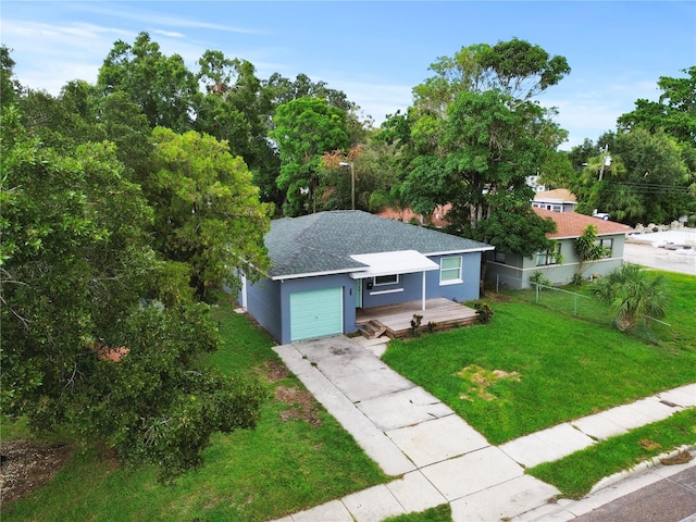 single story home featuring stucco siding, concrete driveway, an attached garage, a front yard, and fence