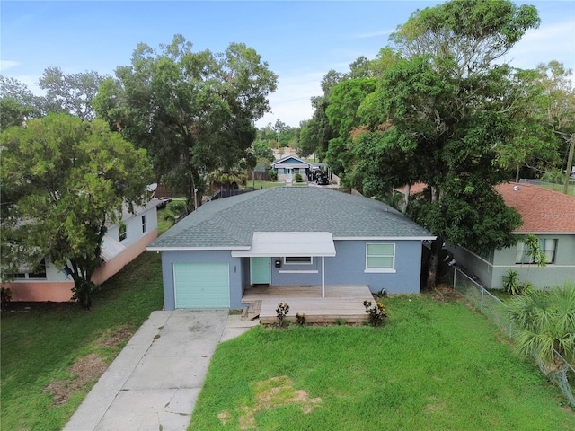 view of front of property with a garage and a front lawn