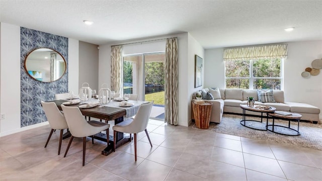 dining room with a wealth of natural light, light tile patterned flooring, and a textured ceiling