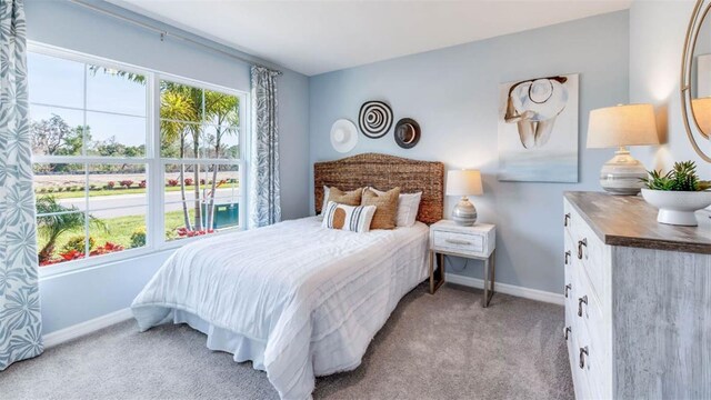 carpeted bedroom featuring multiple windows