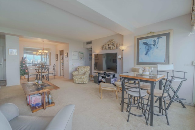 living room featuring an inviting chandelier and light carpet